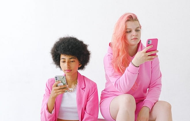 two girls looking at their phone